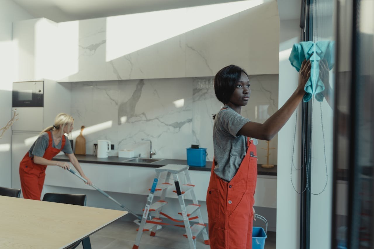 Two maintenance professionals cleaning a modern commercial interior