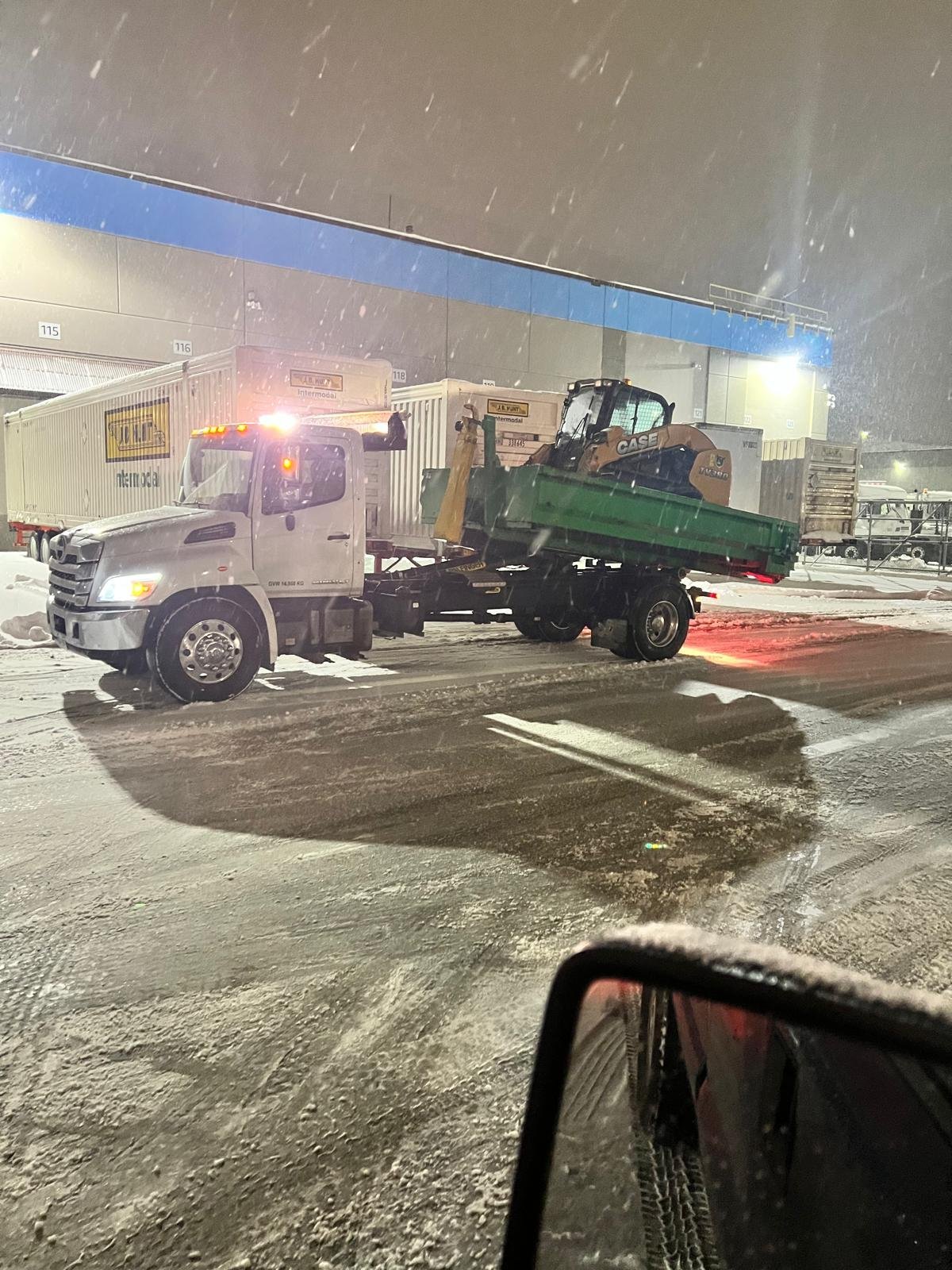 Snow plow operating at night